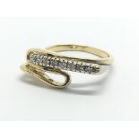 An unusual gold ring set with eight diamonds, appr
