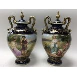 A pair of Vienna porcelain urns and covers. (Restoration to cover).