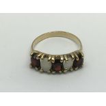 A 9ct gold, opal and garnet ring, approx 2.6g and