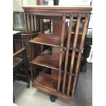 A Edwardian mahogany revolving book with open sections .