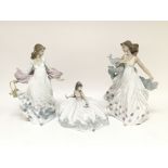 A collection of three Lladró figures of maidens in flowy dresses