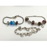 Three silver bracelets, two set with coloured glas