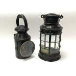 Two painted black metal lamps with glass windows, one marked for Griffiths & Sons, Birmingham