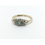 A 9ct gold emerald and diamond cluster ring, appro