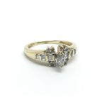 A gold diamond cluster ring set with a central mar