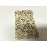 A late 19th century carved ivory card case with foliage and the reverse with figures.