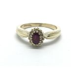 A 9ct yellow gold diamond and ruby cluster ring, a