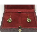 A pair of boxed flower design drop earrings set wi