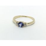 A 14ct gold set with a central tanzanite and two d