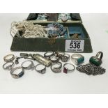 A collection of silver and stone set jewellery in a small vintage sewing box.