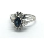 An 18ct gold sapphire and diamond cluster ring, approx 3.4g and approx size N.