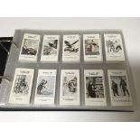 An album of cigarette cards including Speedway Riders, Lawn Tennis Strokes etc