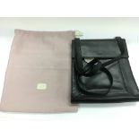 A black Radley satchel bag and dust cover.