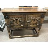 A small oak 2 door cabinet with marquetry inlay to door panels, 99 x 77 x 37cm.