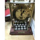 A brass cased mystery spherical weight Limted edition weight clock .