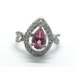 An 18ct white gold ring set with a central pink sa