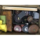A box containing tape measures and rulers.