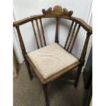 A Edwardian corner chair with drop in seat on turned legs united by stretchers.