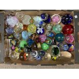 A large collection of paperweights, different size