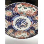 A large Japanese Imari charger decorated with Figu