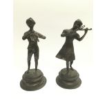 A pair of bronzed figures of child musicians, appr