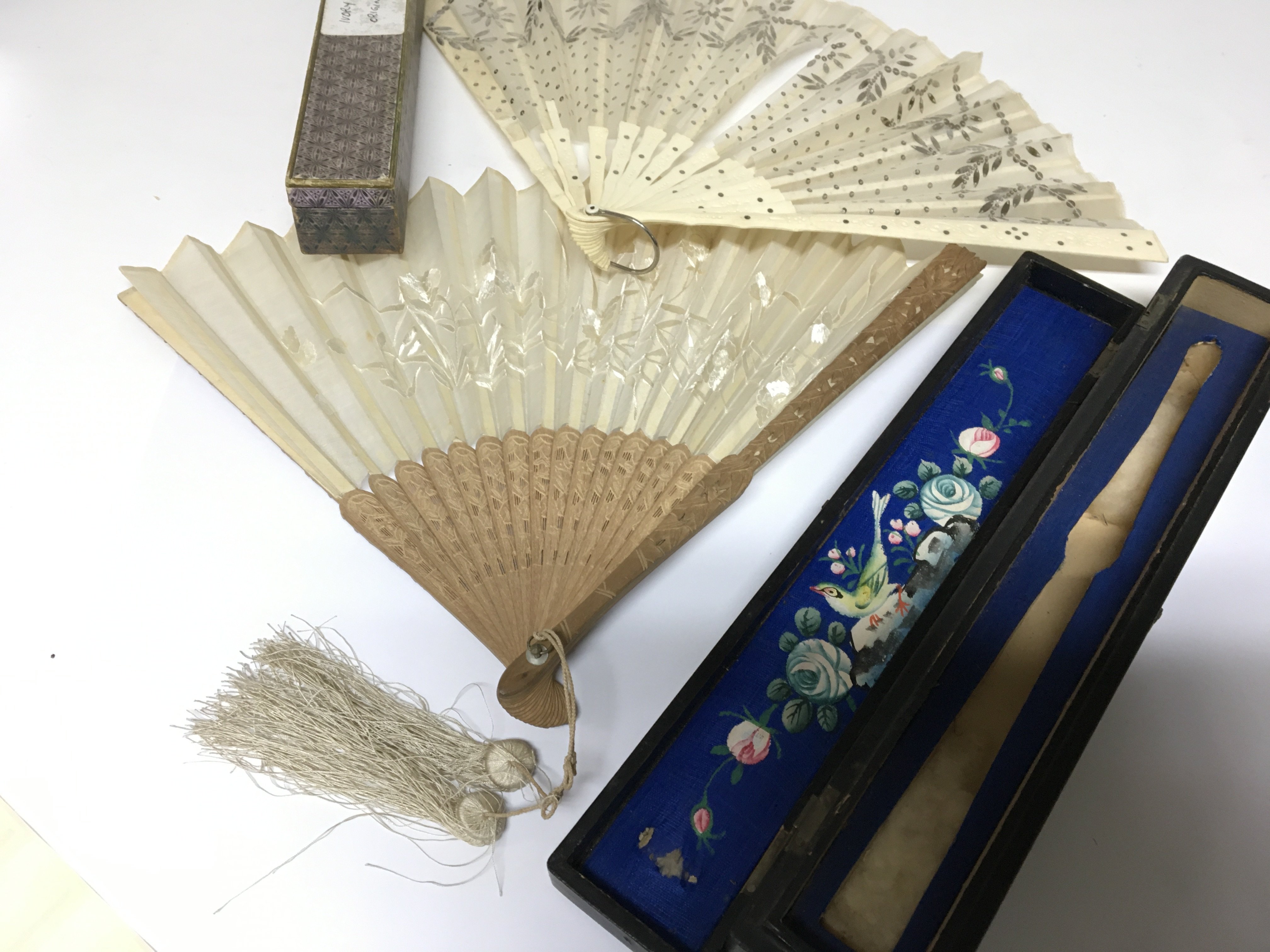 Two vintage fans including a carved sandalwood fan