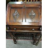 A small oak bureau the fall front above turned leg