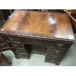 A small reproduction mahogany knee hole desk.