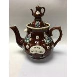 A Victorian basalt tea pot with raised floral deco