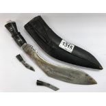 An Indian kukri knife in scabbard with skinning kn