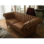 A pair of quality leather Chesterfield sofas with