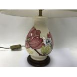 A Moorcroft pottery lamp, hibiscus pattern. 21.5cm