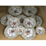 A porcelain set of 11 decorative floral plates and