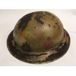 A WW2 British Brodie helmet with insignia of Briti