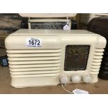 A vintage cream bakelite radio.