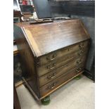 A mahogany bureau in need of restoration, approx 5