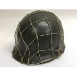 A WW2 US helmet with Capac liner and Cam net. Fron