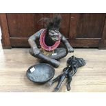 An African carved seated figure with necklace and