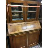 A oak bureau bookcase the glazed doors above a fal