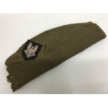 A WW2 British Army side cap with hand embroidered