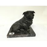 A cast bronze dog ornament in the form of a seated