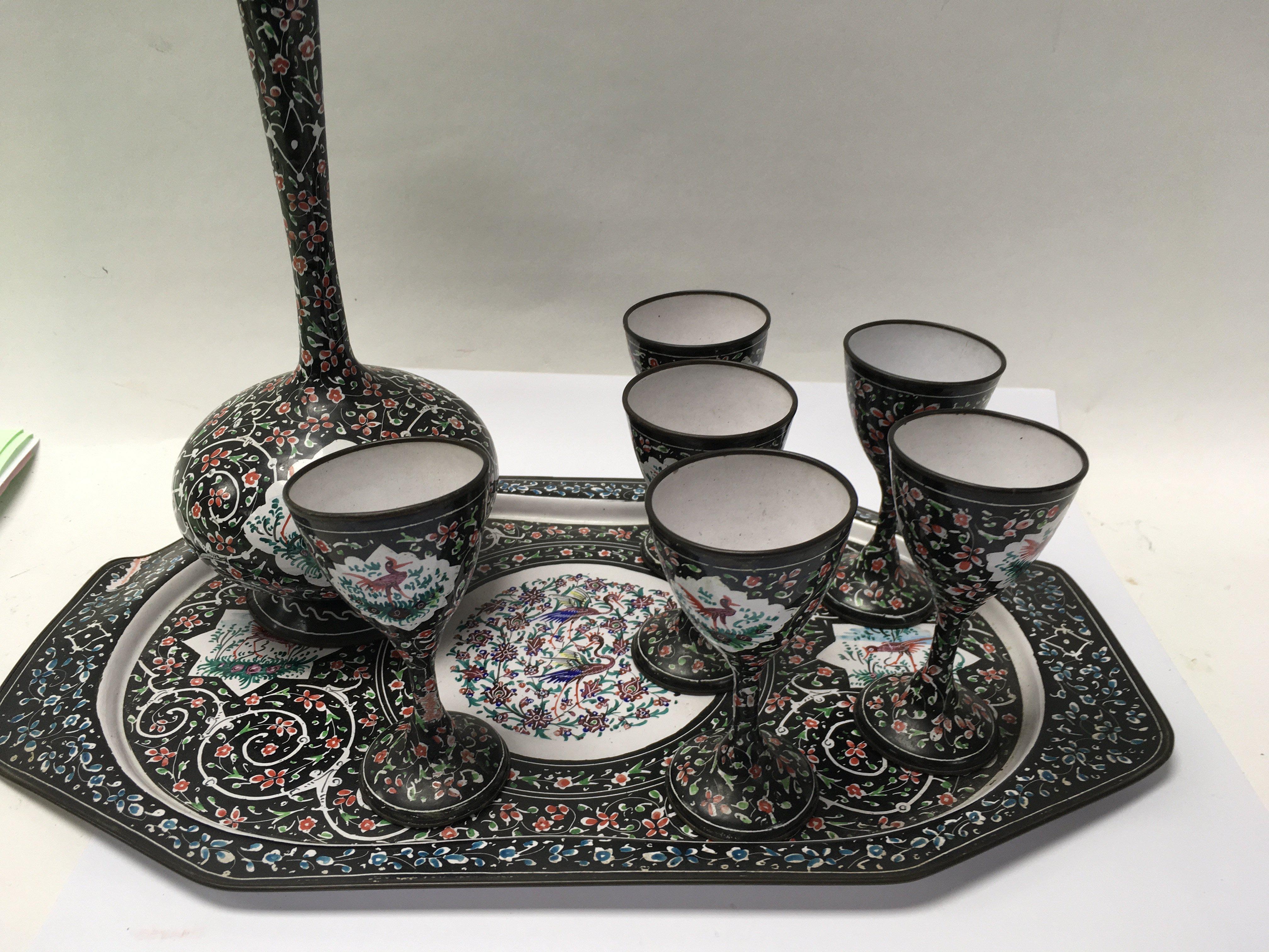 A Indian enamel tray with six matching cups and va