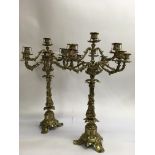 A pair of gilt 9 branch candelabra having classica