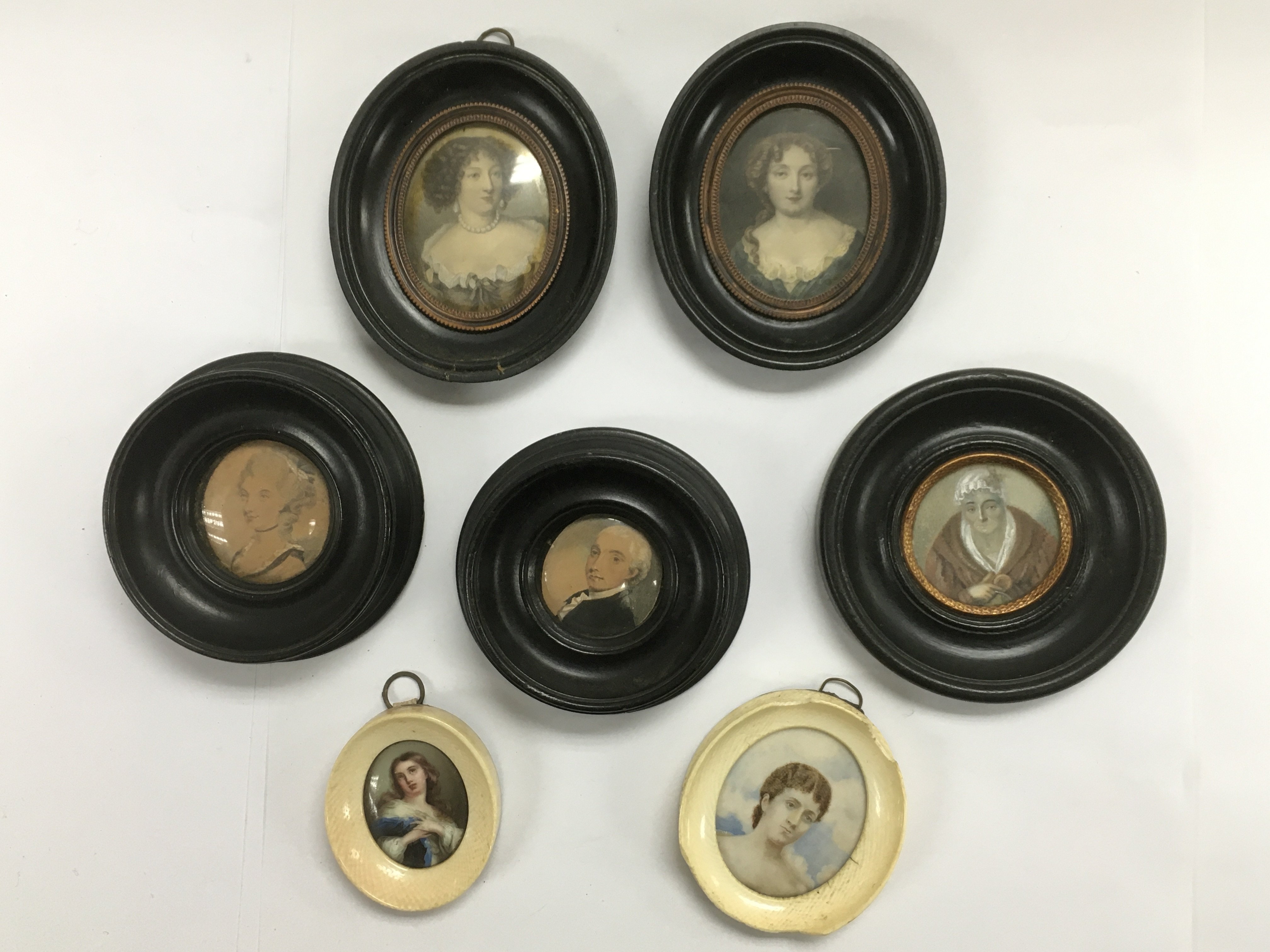 A collection of miniatures, two in ivory frames, s