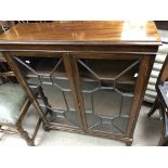 A small mahogany bookcase With glazed doors. 84cm