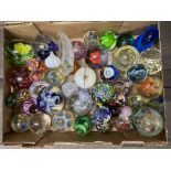A large collection of paperweights , different siz