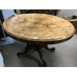 A Victorian burr walnut loo table with an oval top