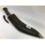 A large kukri in scabbard with small skinning knif