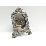 An ornate Victorian style mirror decorated with ch