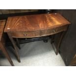 A reproduction mahogany side table fitted with two
